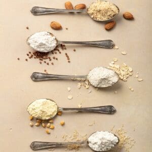Metal spoons of various gluten free flour almond flour, oatmeal flour, buckwheat flour, rice flour,